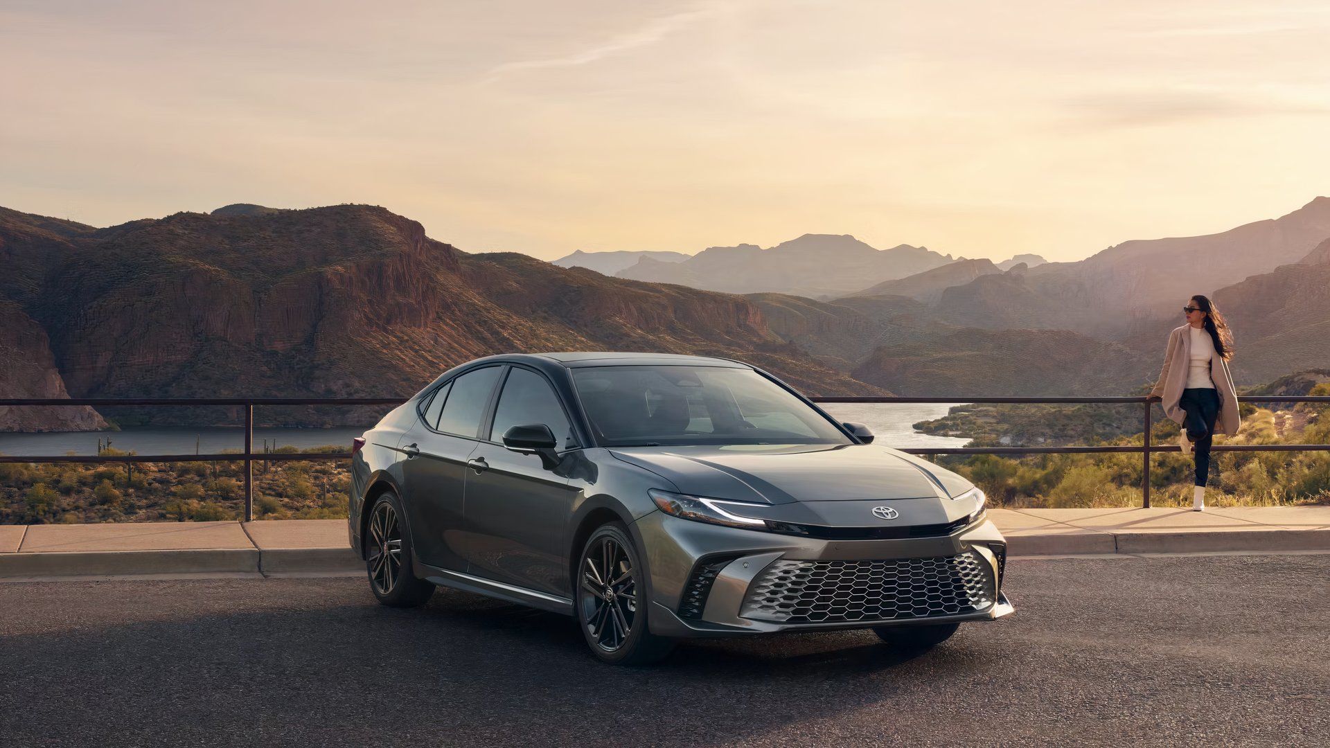 A gray 2025 Toyota Camry midsize sedan is parked. 