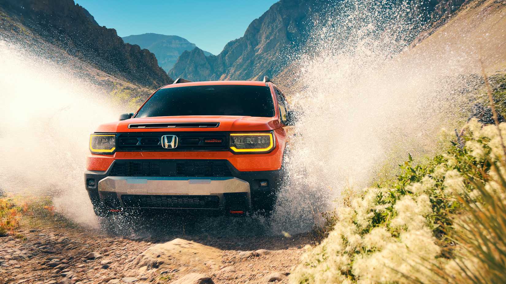 2026 Honda Passport in orange being driven off-road