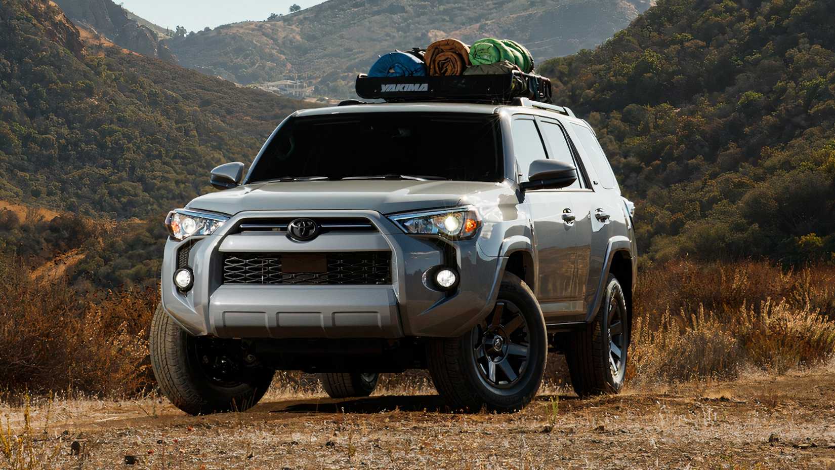 2021 Toyota 4Runner in silver parked off-road with roof bars loaded up
