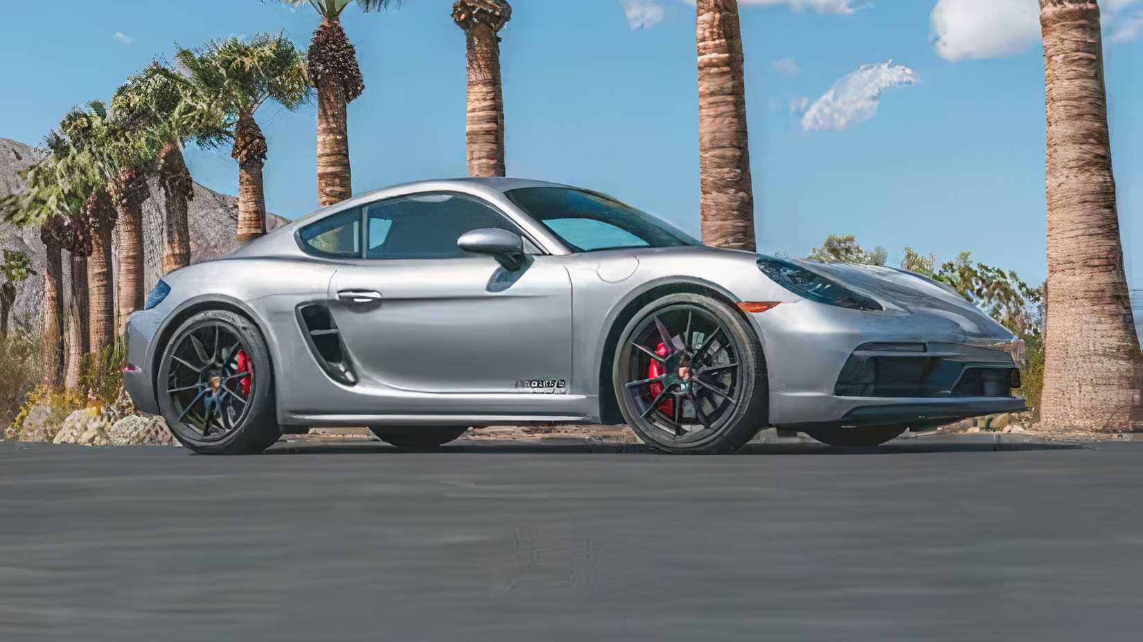 2024 Porsche Cayman GTS 4.0 in silver posing in front of palm trees on road