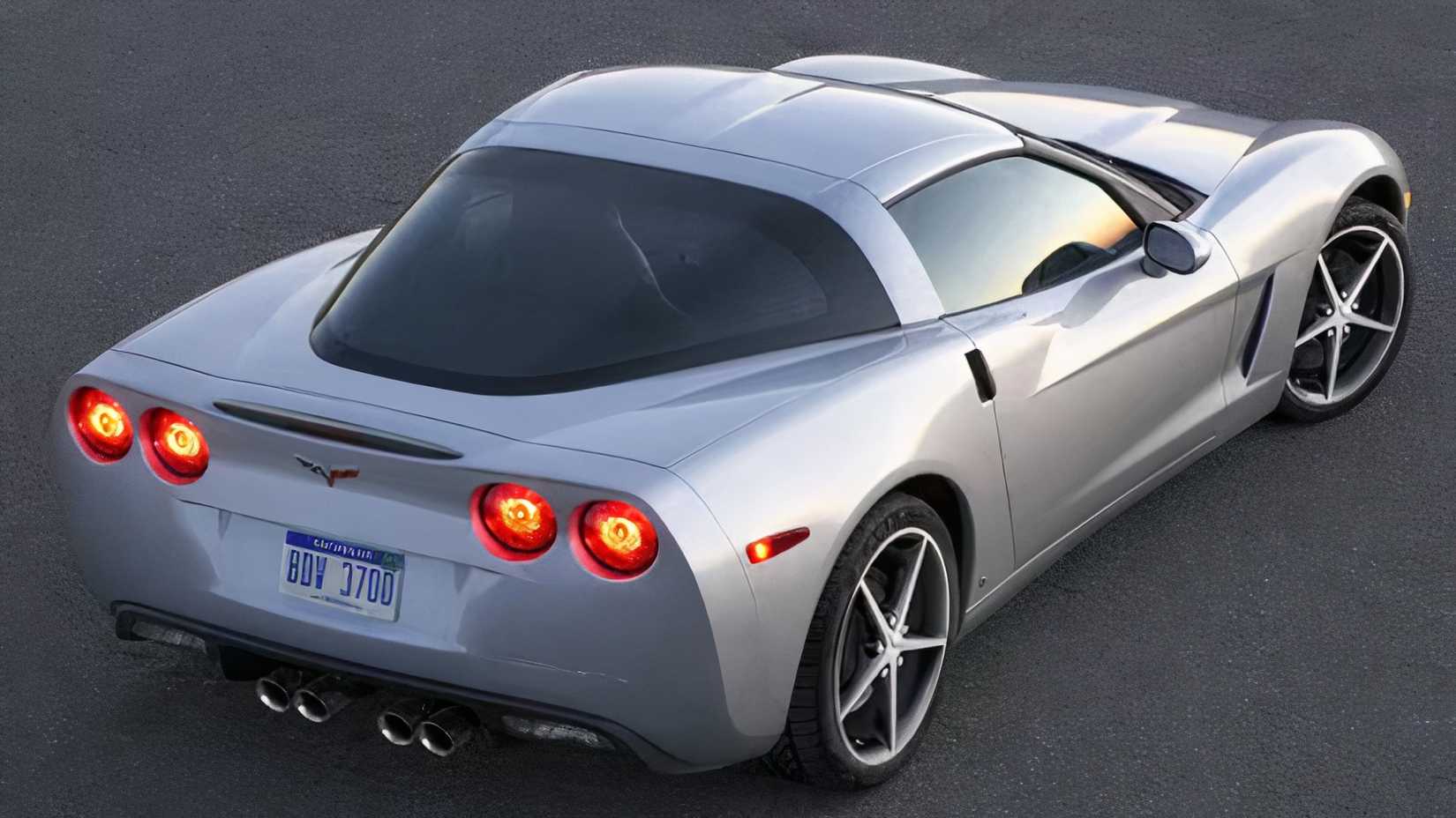 2011 Chevrolet Corvette in silver posing on road