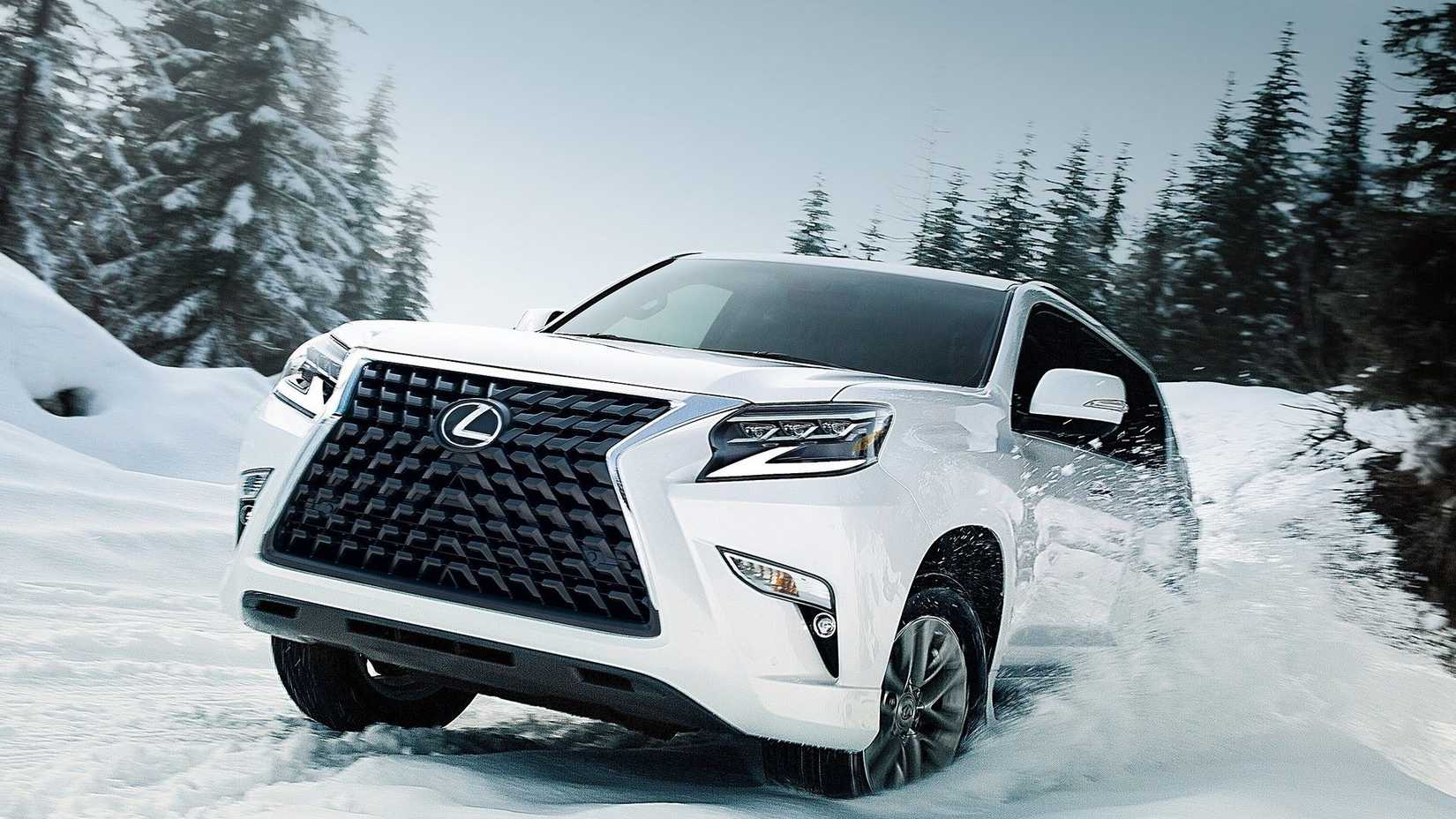 Front 3/4 action shot of a white 2020 Lexus GX plowing through snow