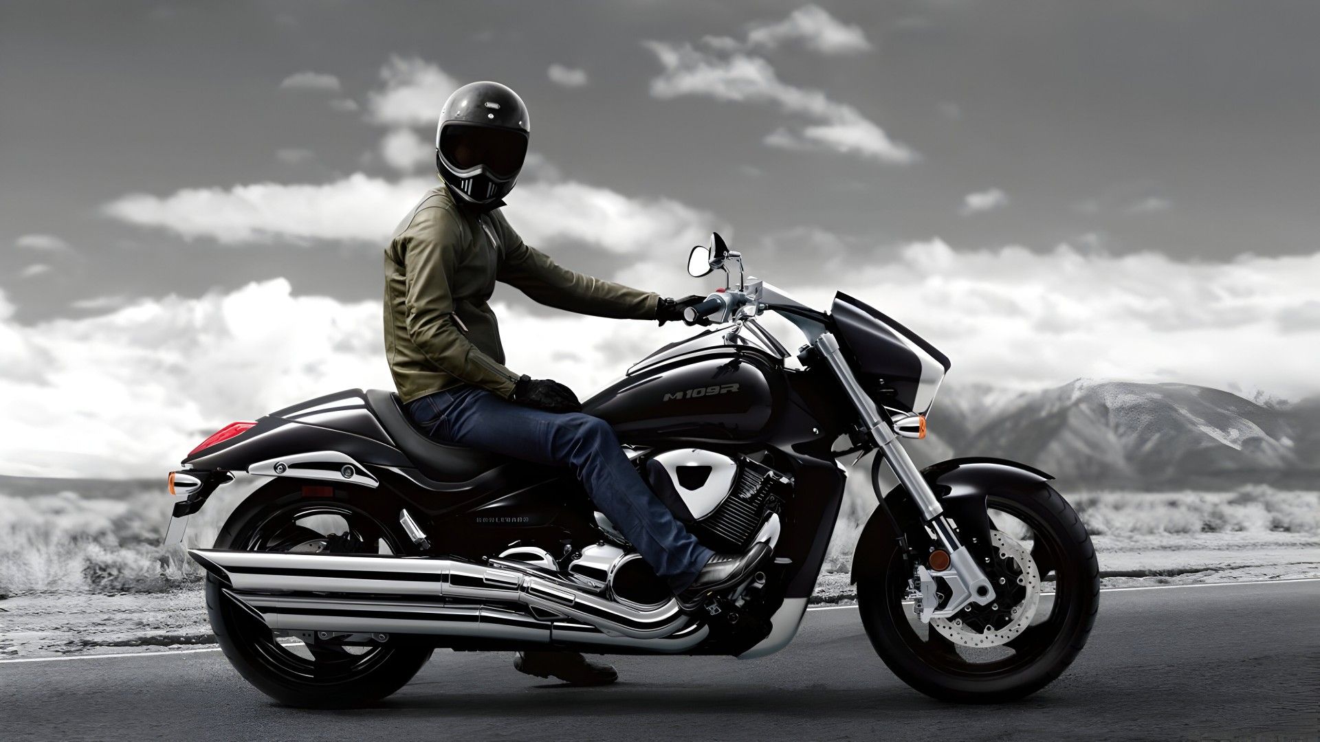 Perfil lateral do Suzuki Boulevard M109R com piloto posando em frente a uma montanha