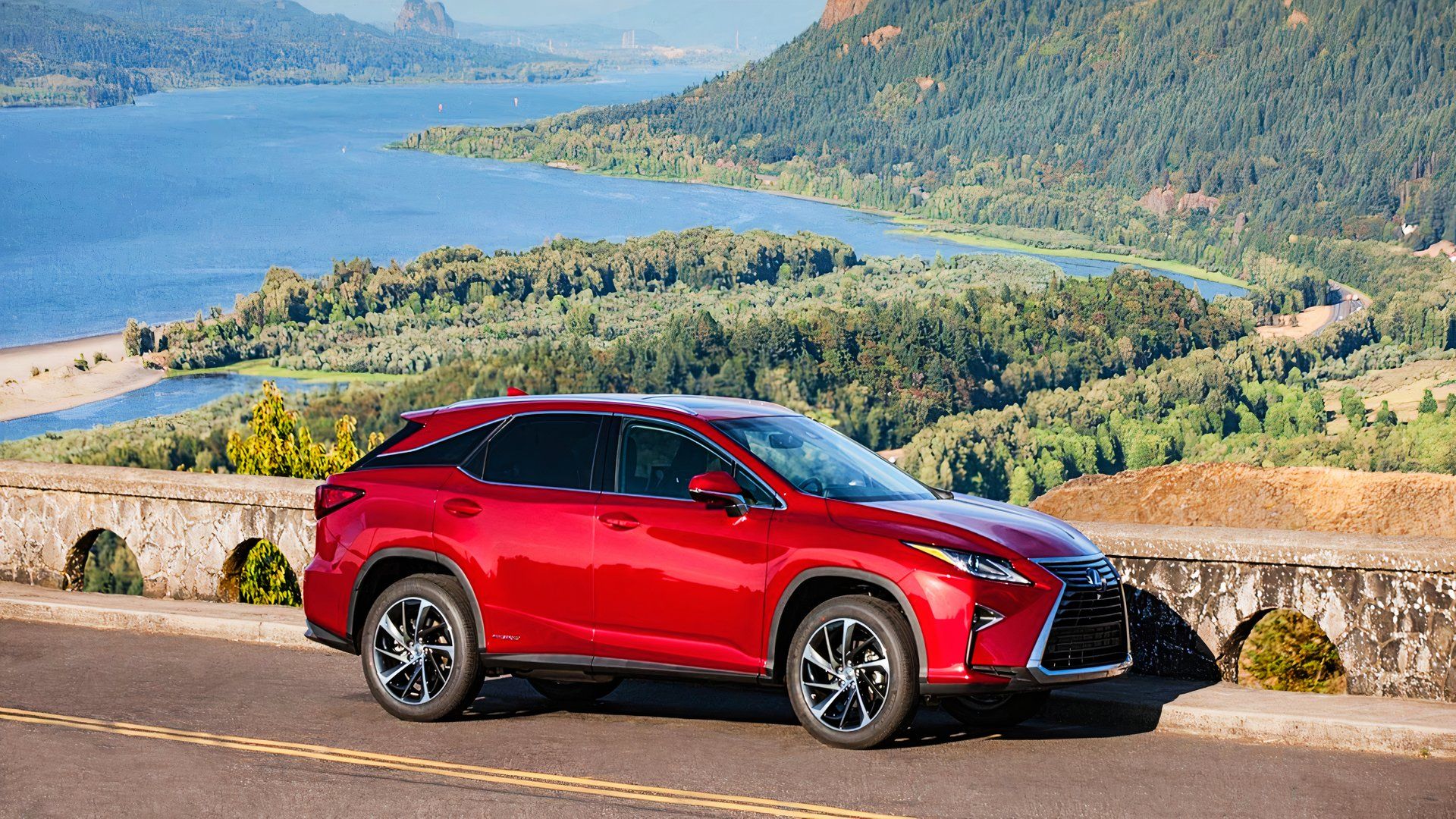 A red 2019 Lexus RX450h midsize hybrid SUV is parked. 