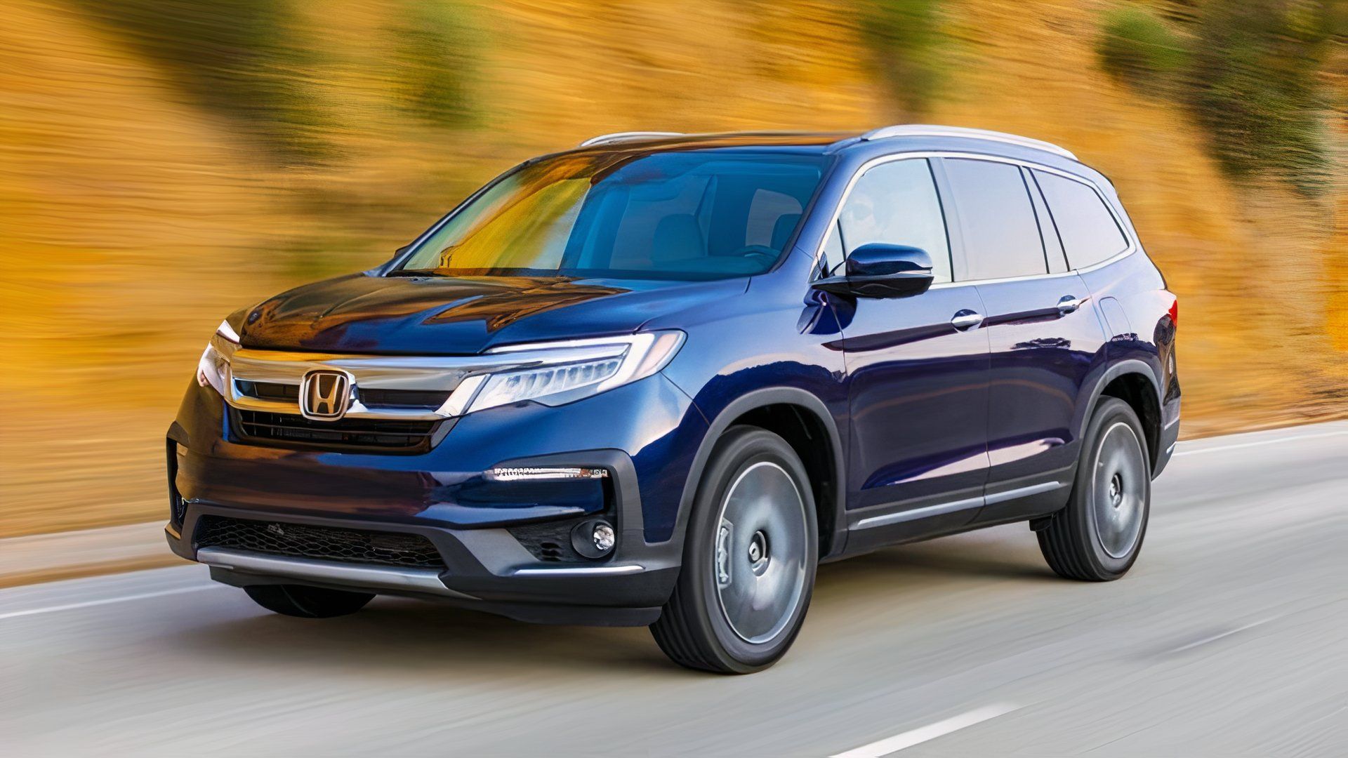 2020 Honda Pilot in blue driving along a road