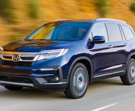 2020 Honda Pilot in blue driving along a road