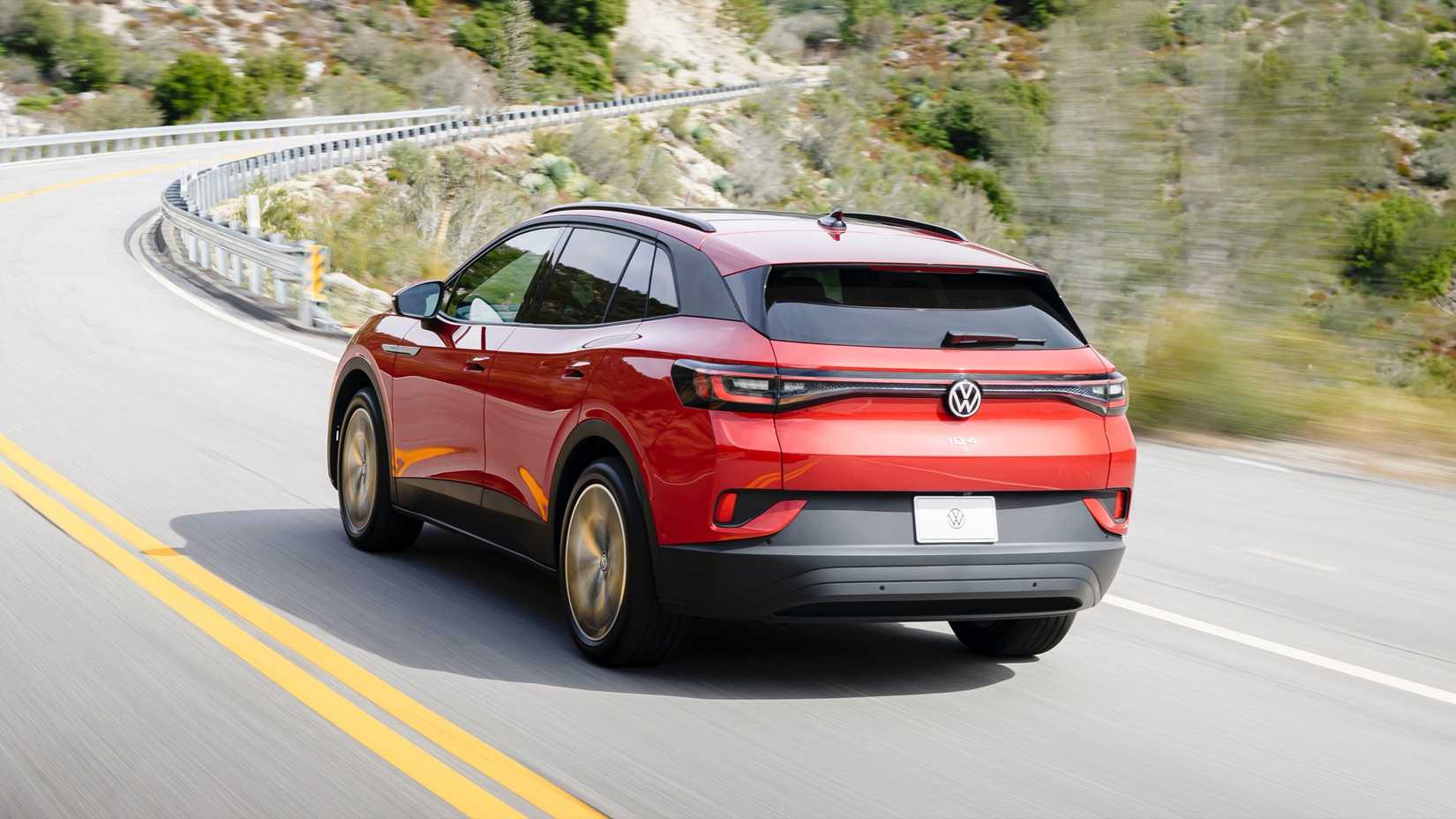 2024 Volkswagen ID.4 in red, rear three-quarters driving shot