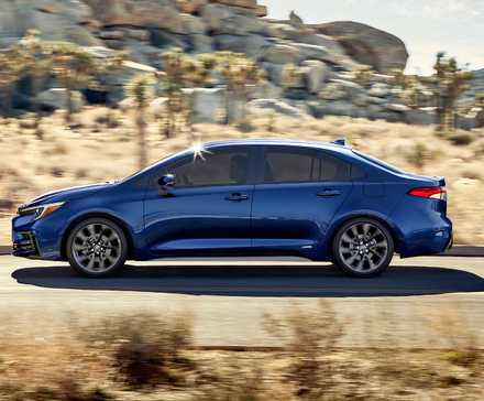 Side profile shot of a blue 2025 Toyota Corolla Hybrid in action