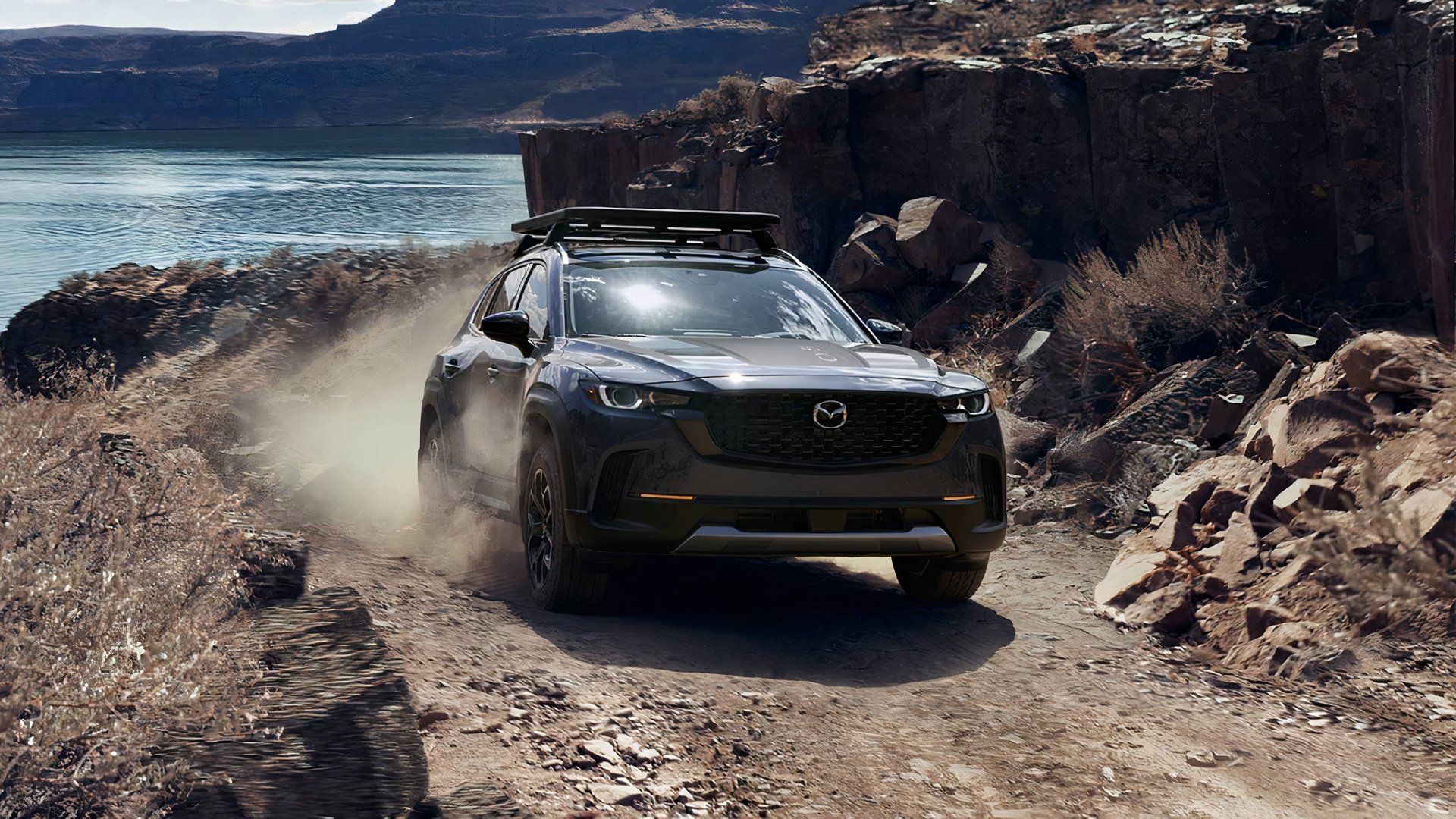 2025 Mazda CX-50, front 3/4 climbing rocky hill