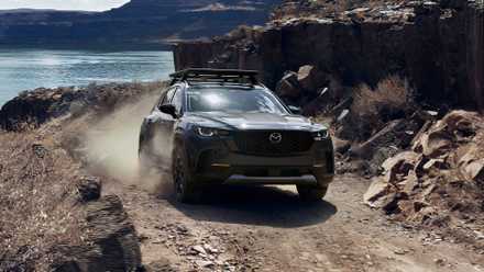 2025 Mazda CX-50, front 3/4 climbing rocky hill