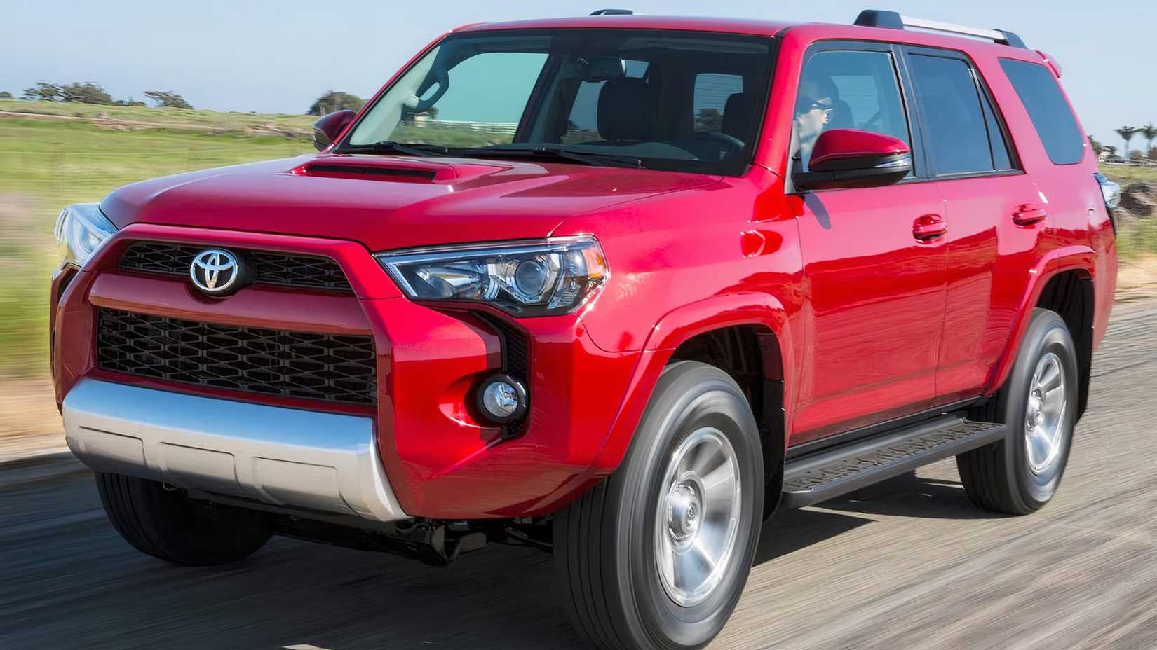 2015 Toyota 4Runner Trail Premium in red driving on highway