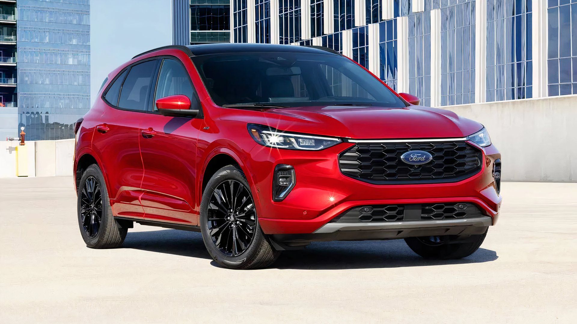 2023 Ford Escape Hybrid in red parked outside of office building