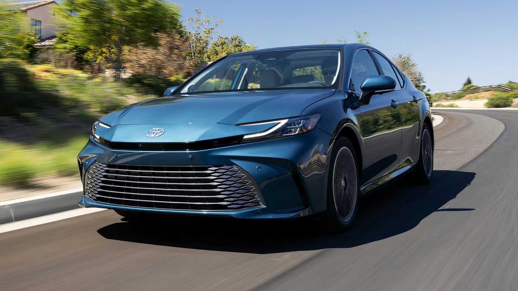 2025 Toyota Camry Hybrid XLE in blue driving along road