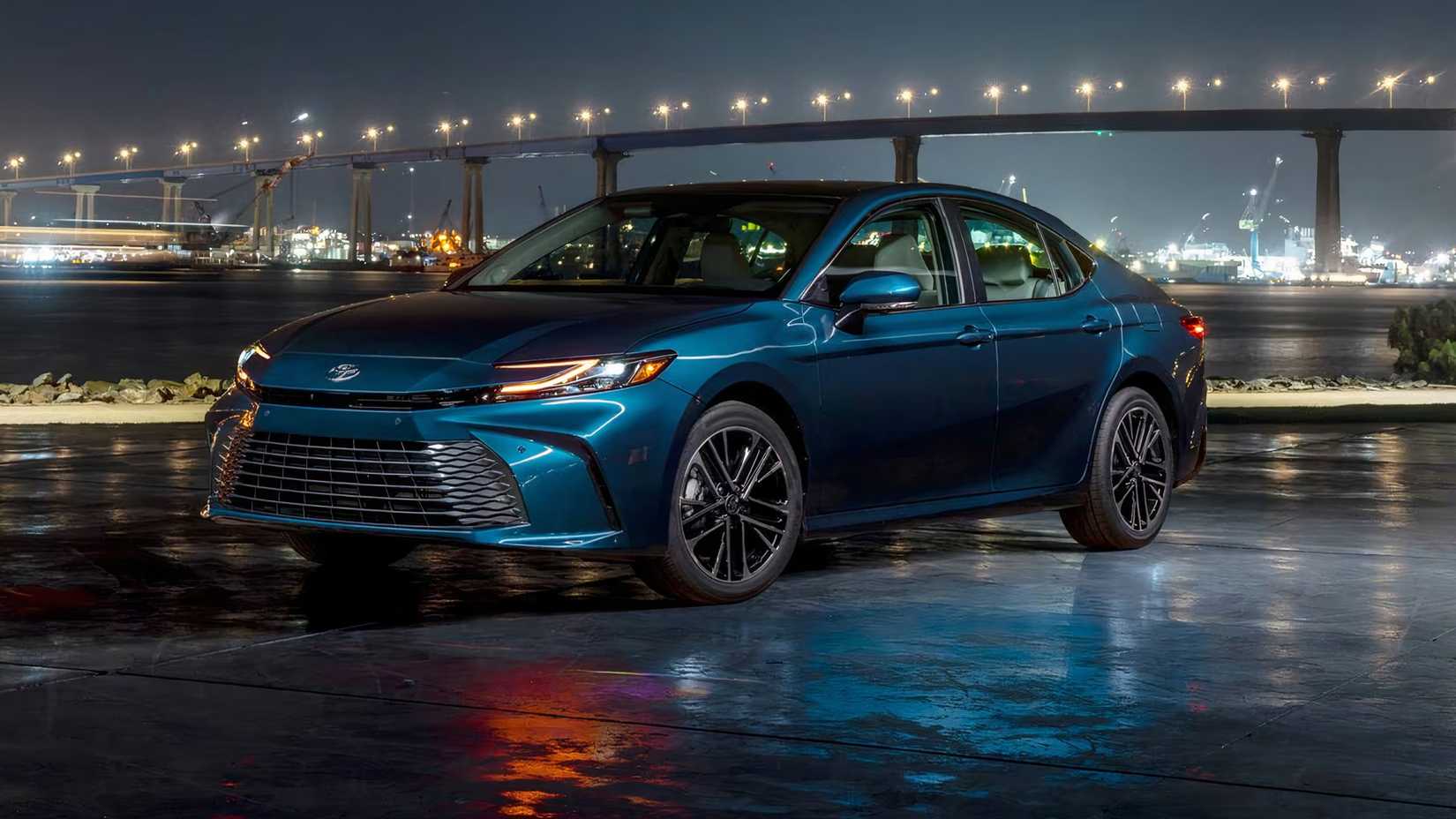2025 Toyota Camry XLE in blue posing in front of bridge