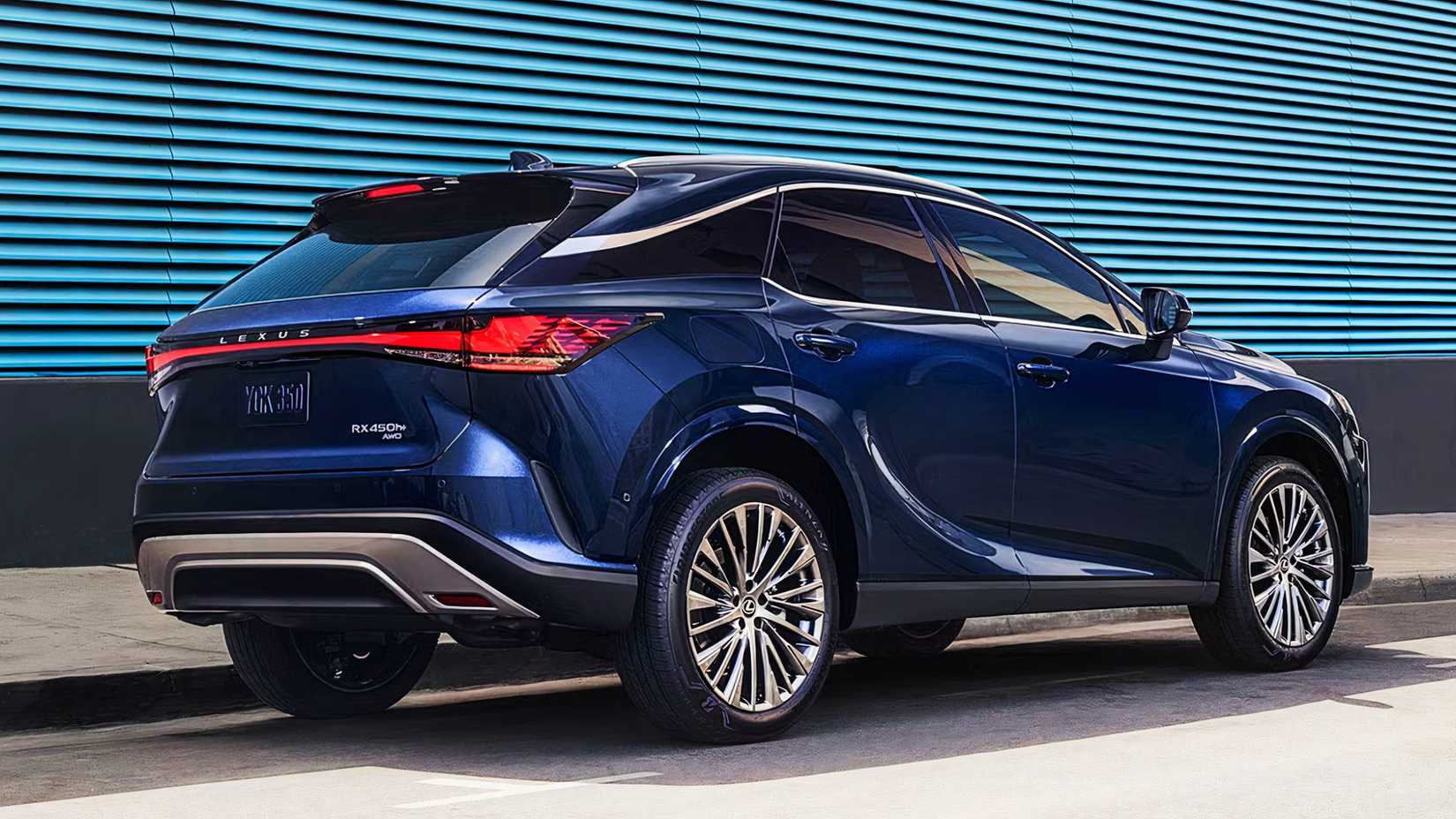 A blue Lexus RX Plug In Hybrid midsize hybrid SUV is parked. 