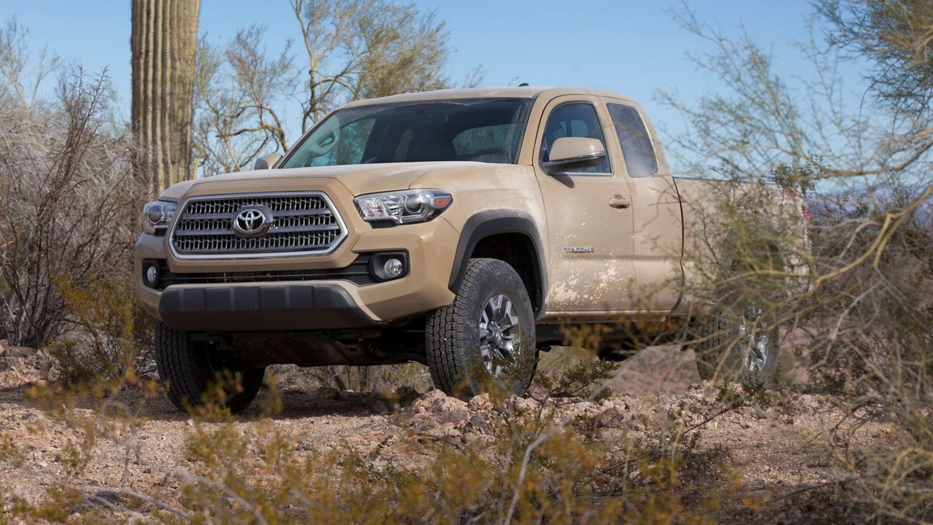 2017 Toyota Tacoma in brown posing off-road. parked under trees