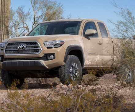 2017 Toyota Tacoma in brown posing off-road. parked under trees