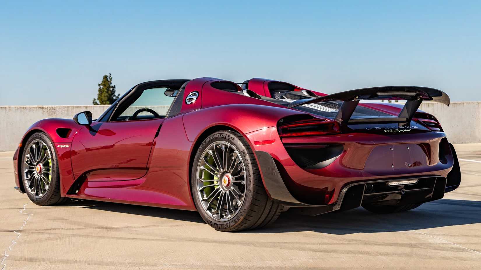 Rear three-quarters shot of a red 2015 Porsche 918 Spyder Weissach Edition