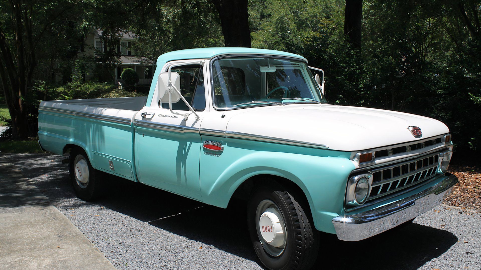 1965 Ford F250 Custom Cab in green and white parked in parking lot