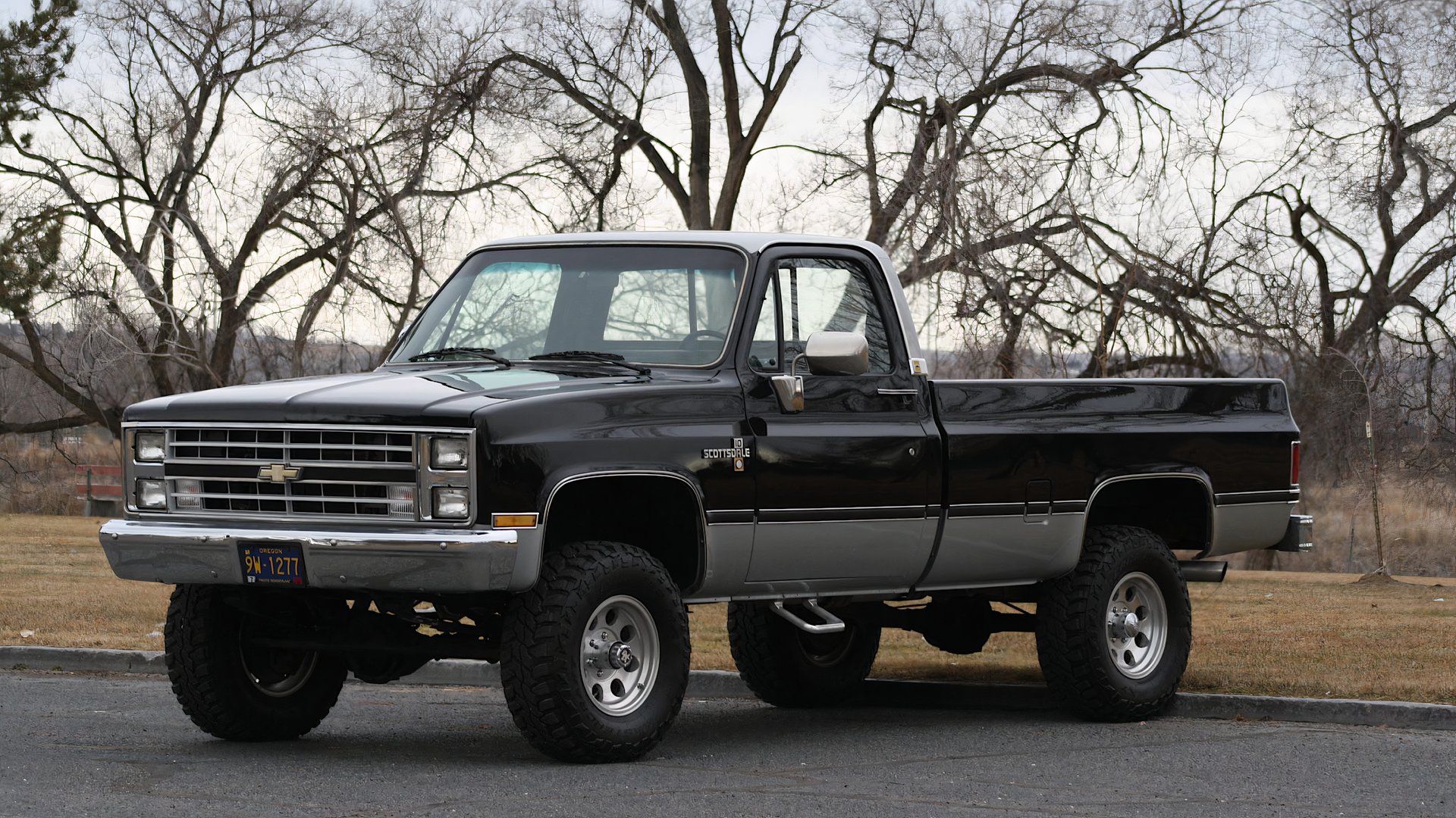 1985 Chevrolet K10 Scottsdale in black parked in parking lot