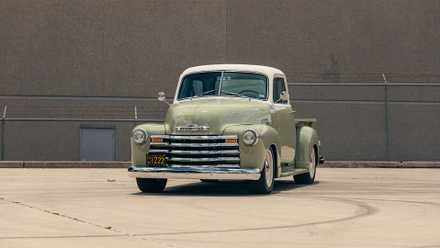 1950 Chevrolet 3100 in green parked in parking lot