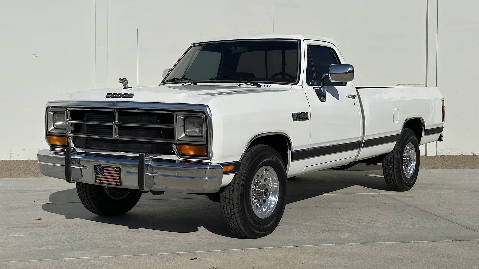 1990 Dodge Ram D250 parked next to warehouse
