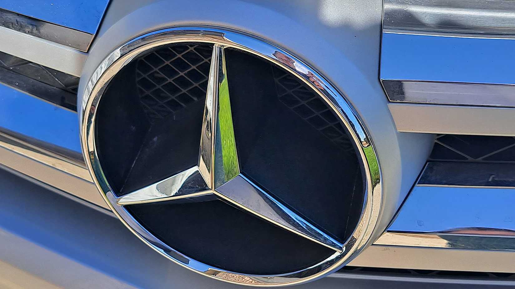 Mercedes-Benz badge on grille of 2012 Mercedes-Benz GLK350 in silver