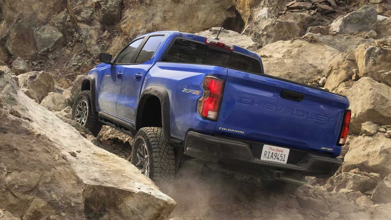 2025 Chevrolet Colorado in blue traversing rocky terrain