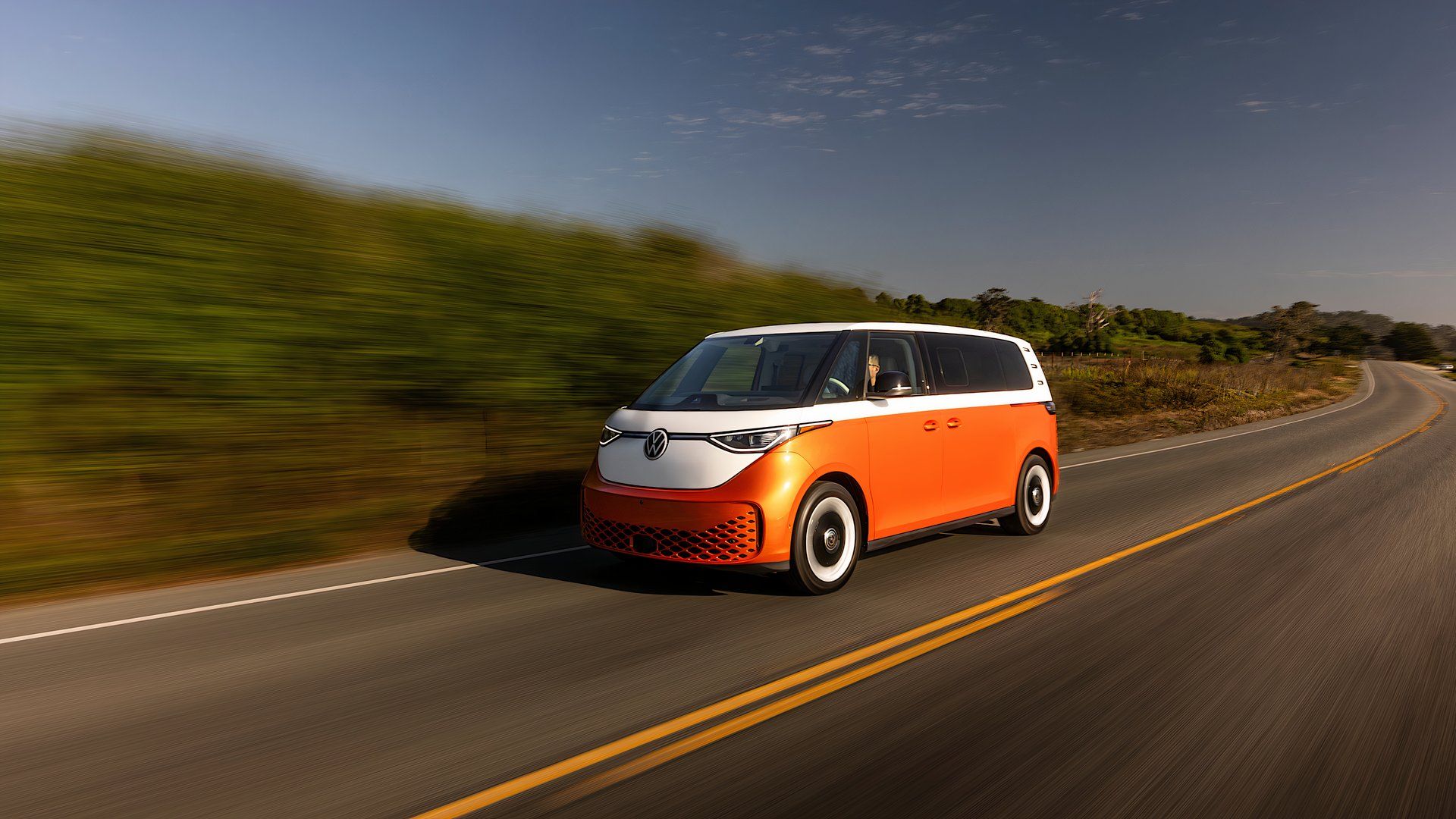 2025 Volkswagen ID. Buzz in orange and white driving on road