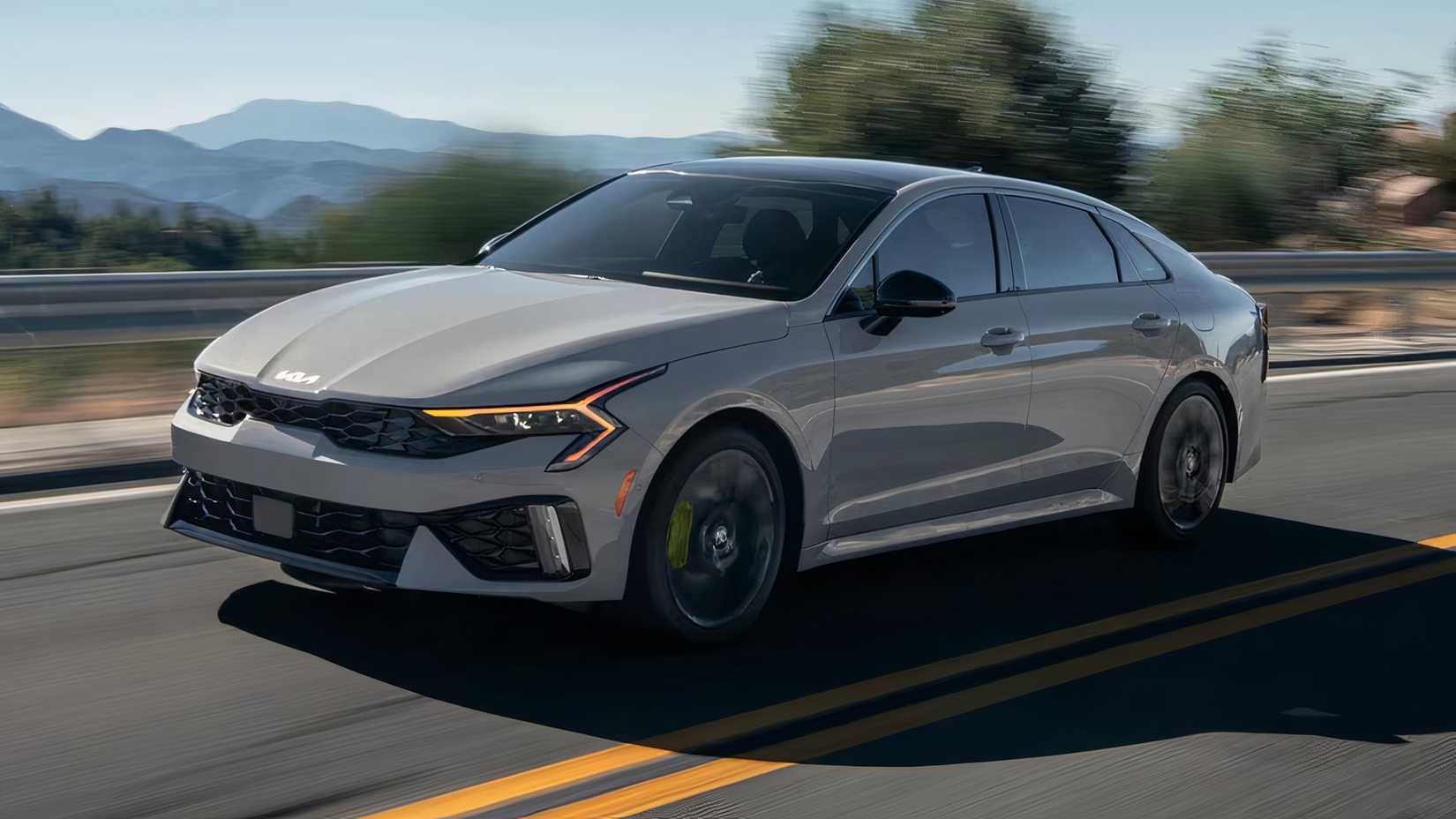 2025 Kia K5 GT Sedan in silver driving on road