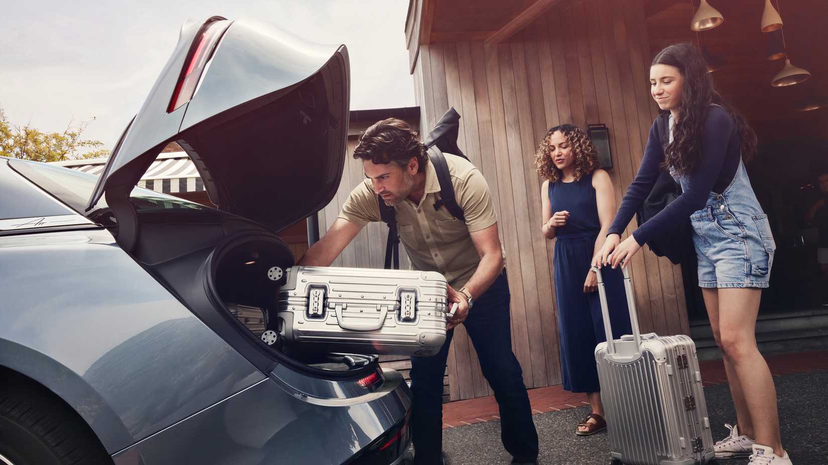 Side angle shot of a family loading cargo in the Lucid Air Pure
