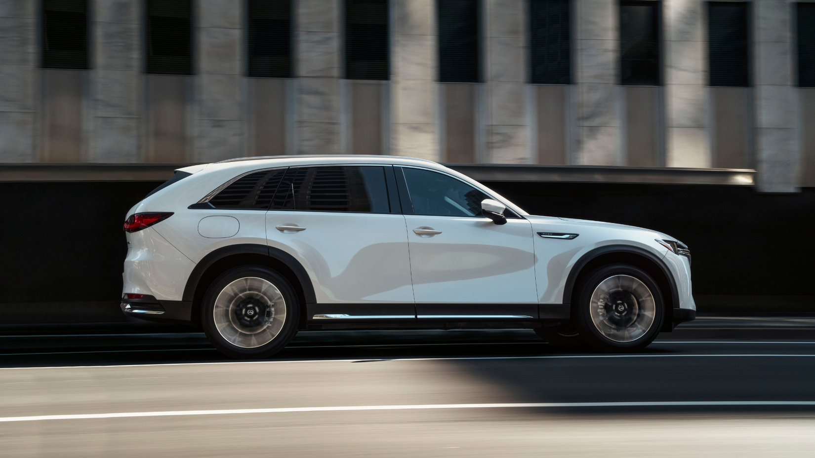 2025 Mazda CX-90 PHEV in white being driven