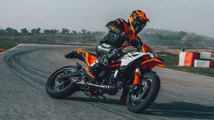 2025 KTM 390 SMC R supermoto sliding on racetrack