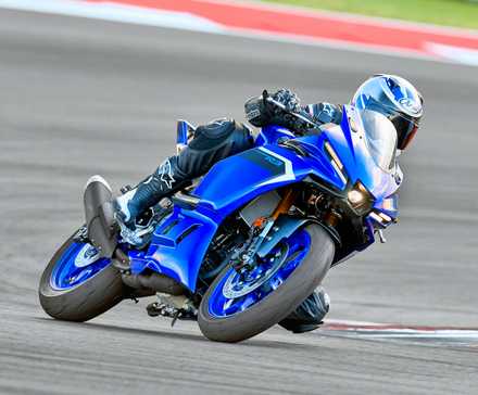 Rider on a 2025 Yamaha YZF-R3 cornering on a track
