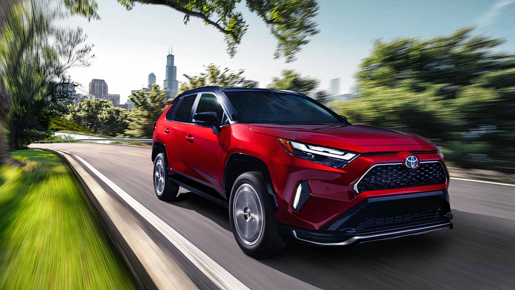 A red Toyota RAV4 Plug-In Hybrid is driving. 