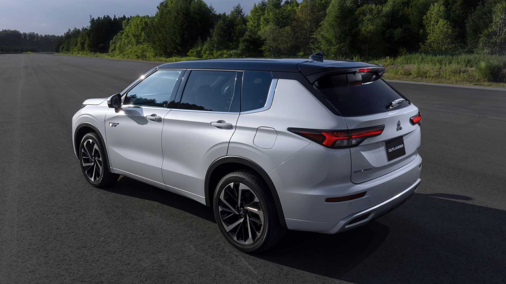White 2025 Outlander PHEV exterior side profile parked on road
