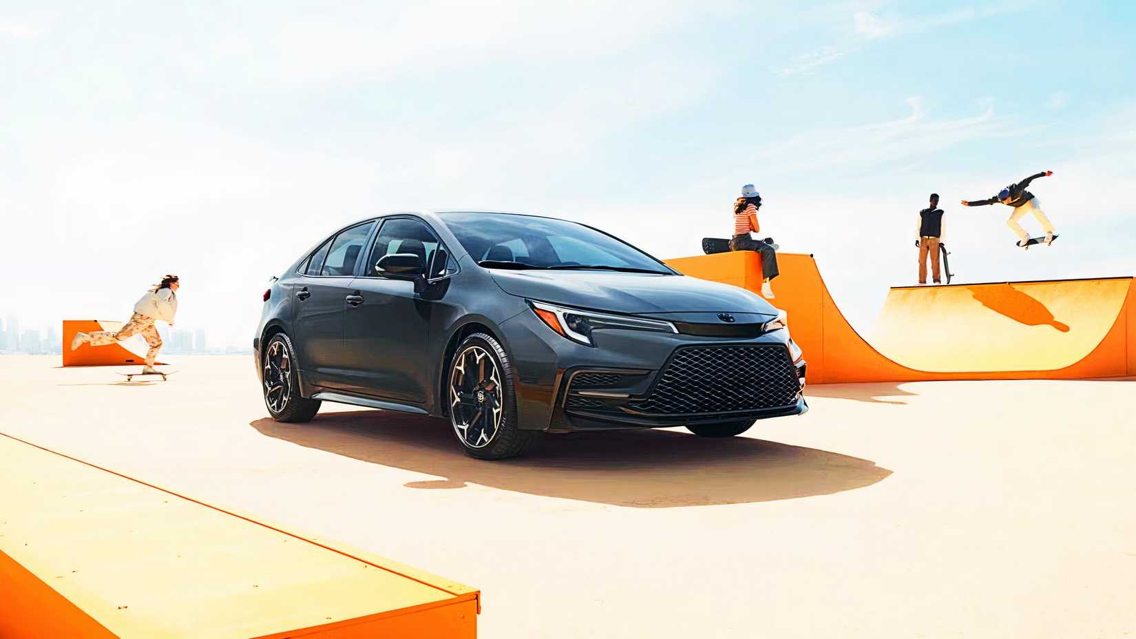 A gray 2025 Toyota Corolla Hybrid sedan is parked.