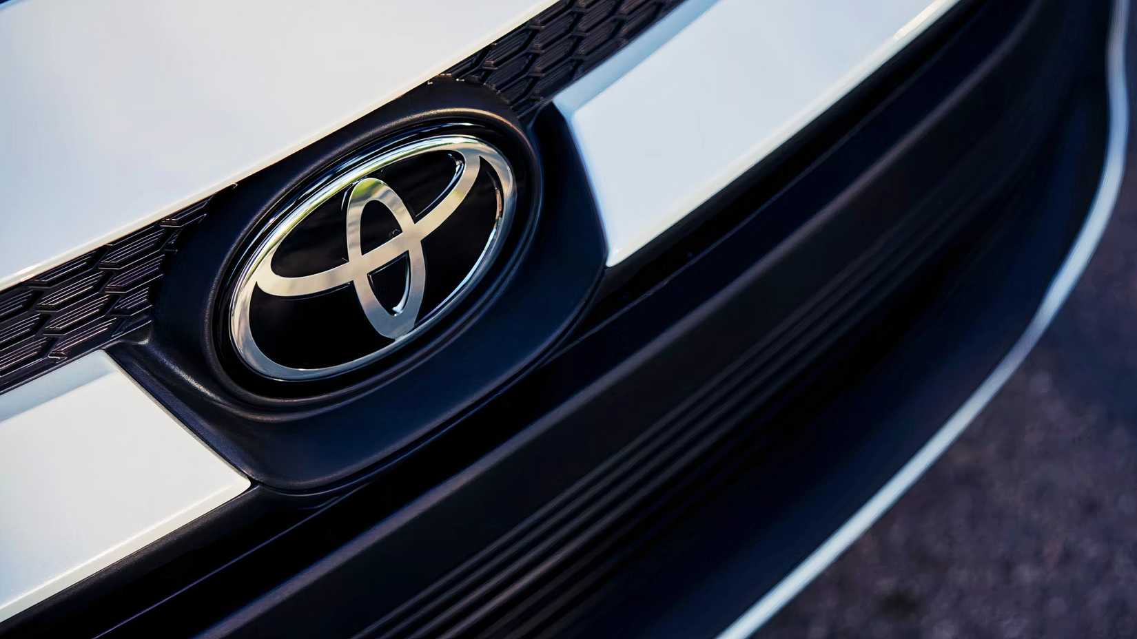 The front of a white Toyota Corolla Hybrid sedan.