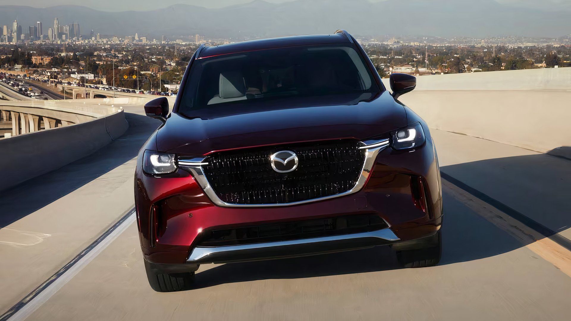 2025 Mazda CX-90 3.3 Turbo S Premium Plus in maroon driving on highway