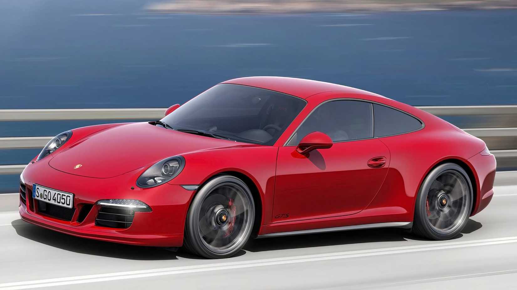 2015 Porsche 911 Carrera GTS in red driving on coast road