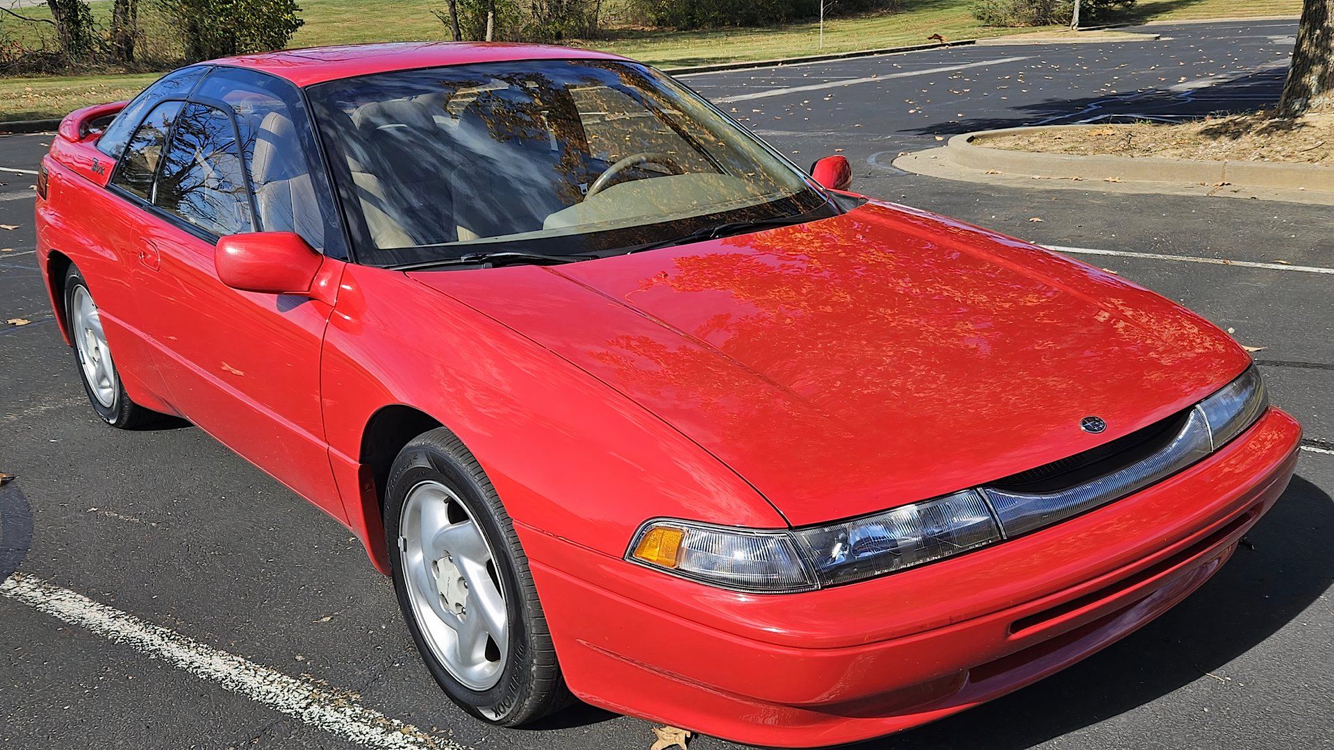 1996 Subaru SVX in red parked in parking lot