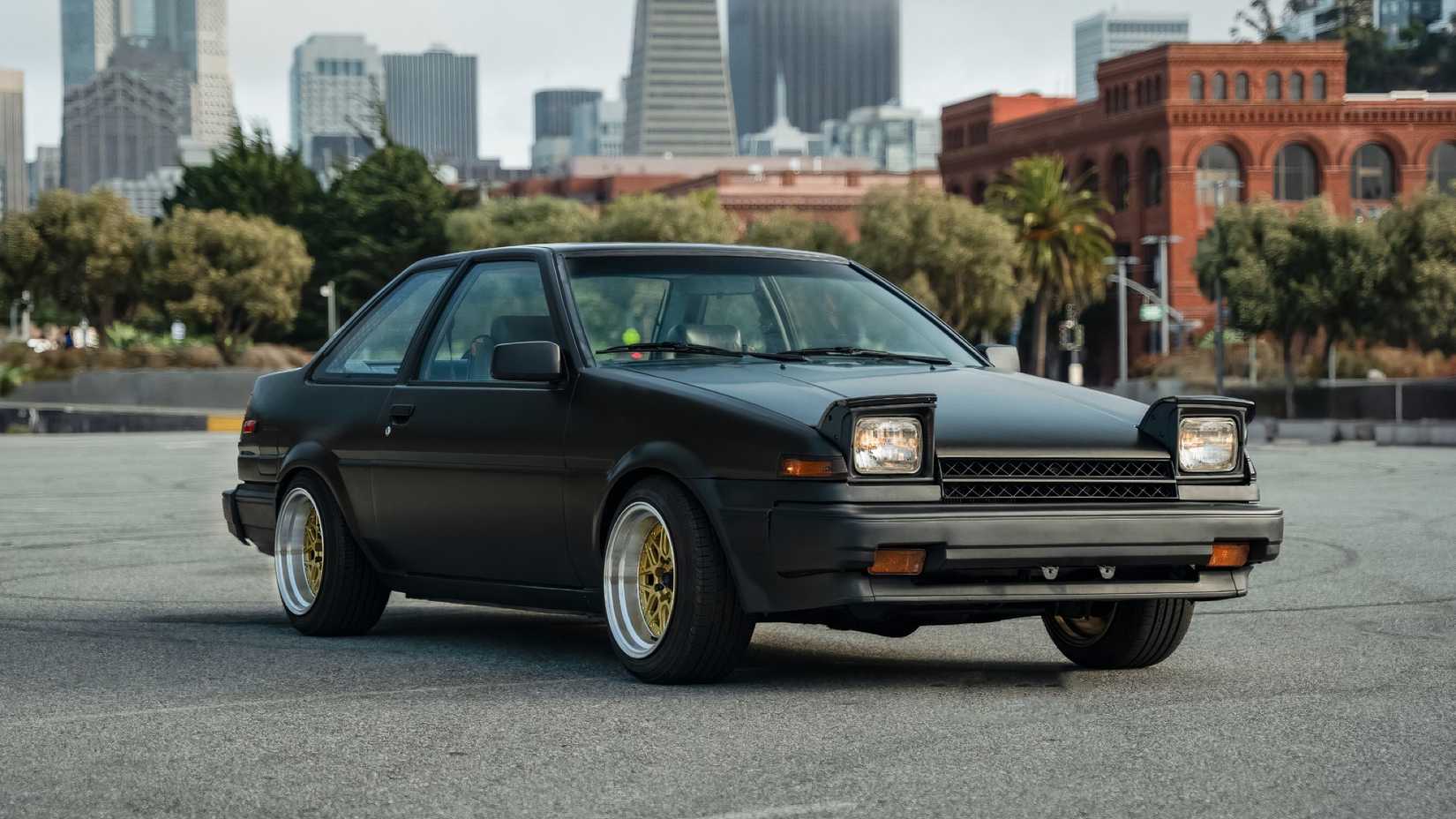 1986 Toyota AE86 Corolla in black parked in parking lot