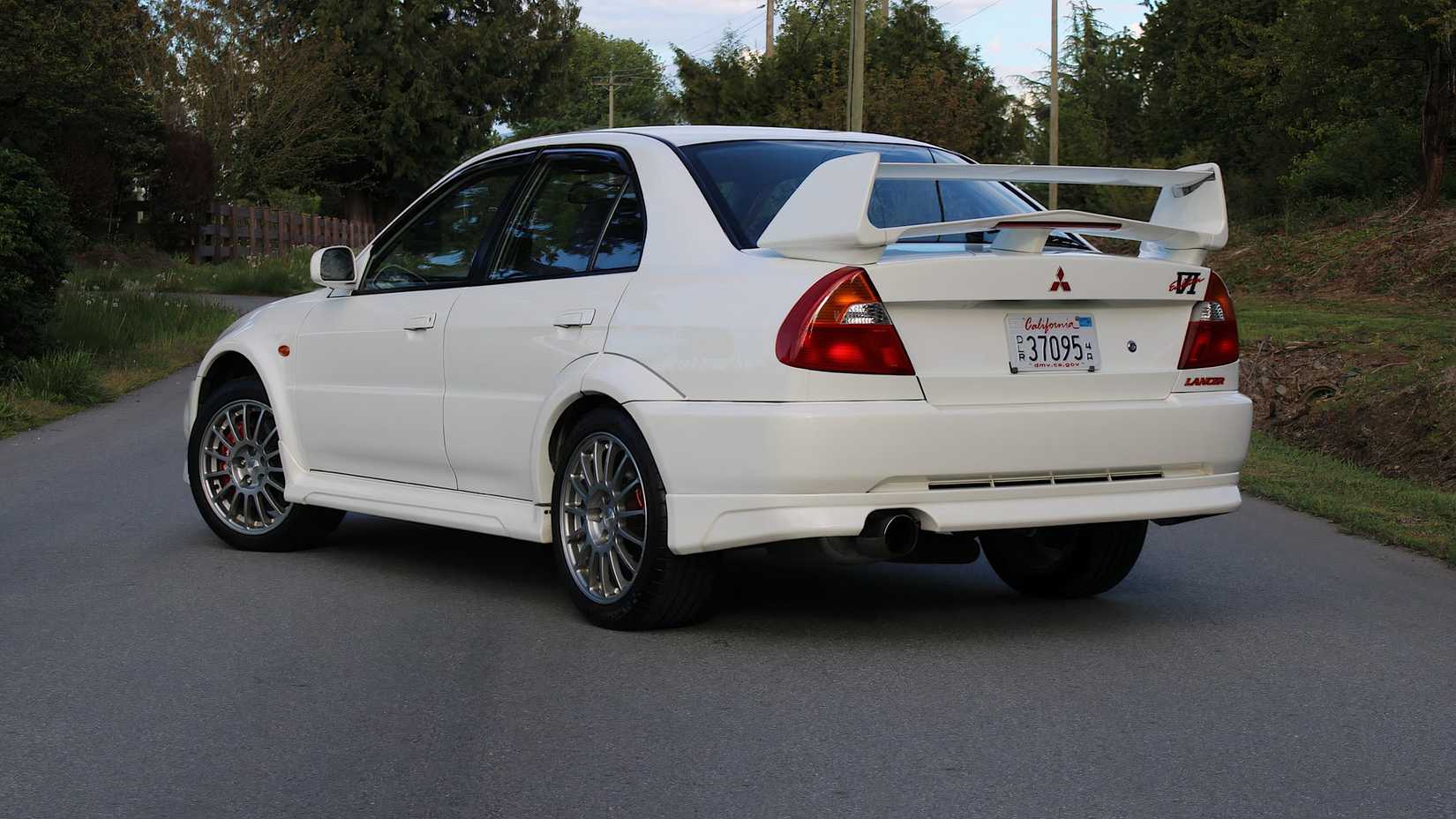 1999 Mitsubishi Lancer Evolution VI GSR in white parked on road