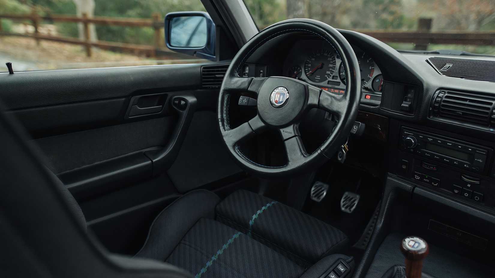1989 Alpina B10 interior showing driver seat and cockpit