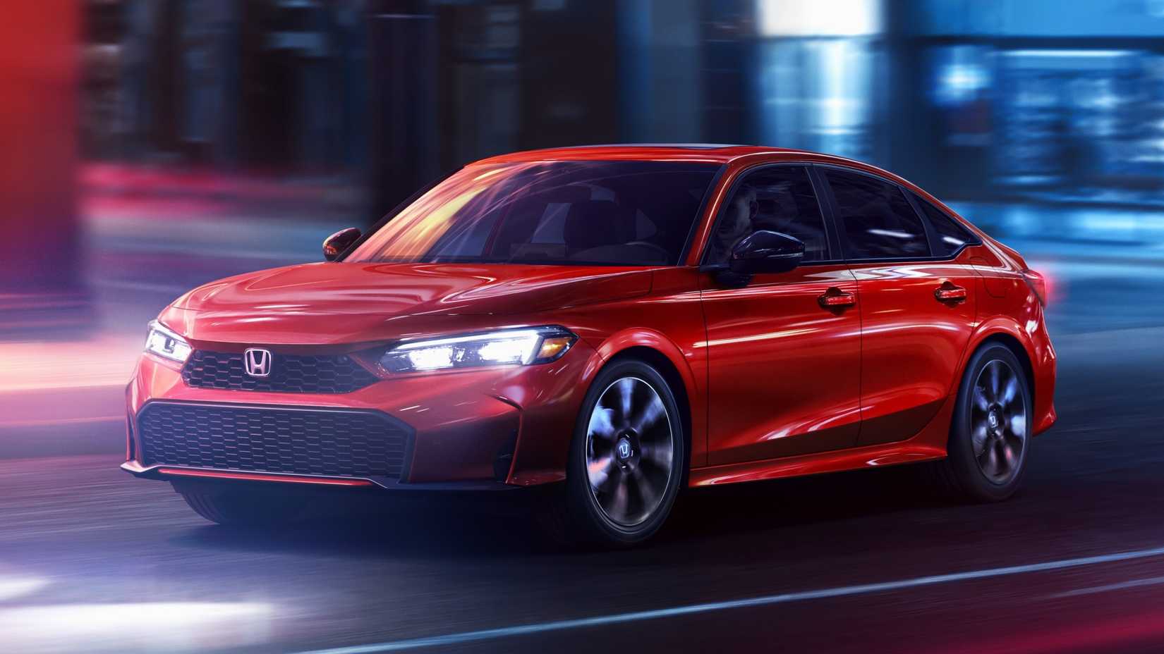 Front 3/4 shot of a red 2025 Honda Civic Sedan Sport Touring Hybrid in motion
