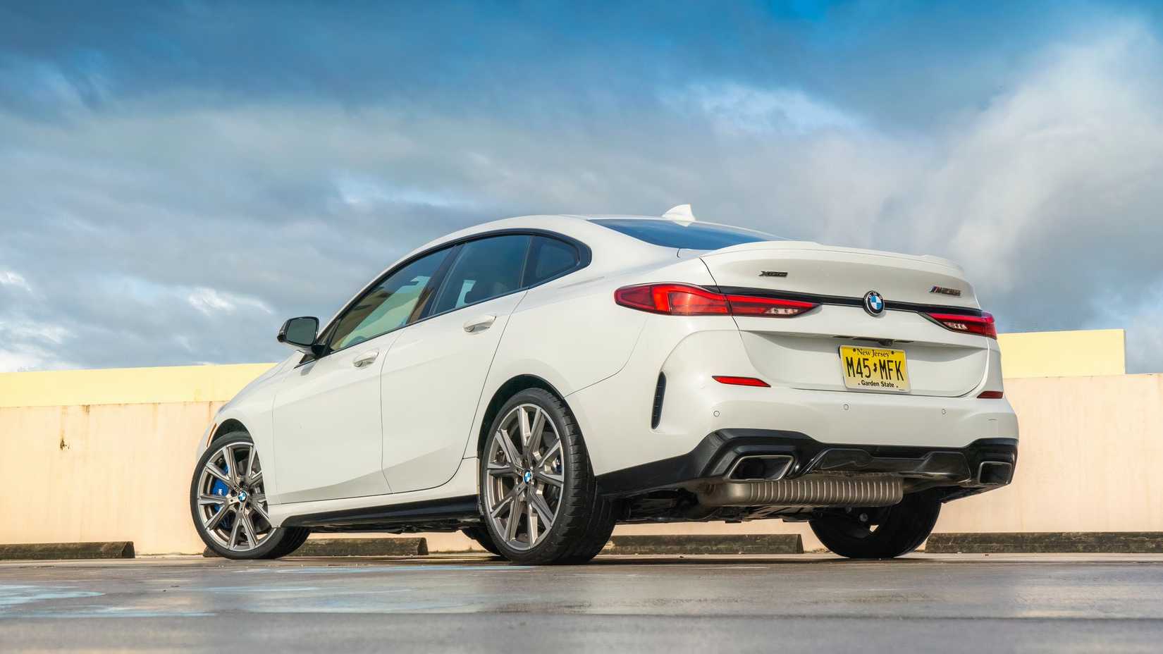 A sleek BMW M235i Gran Coupe parked on a scenic overlook, showcasing its sporty design and performance-ready stance.