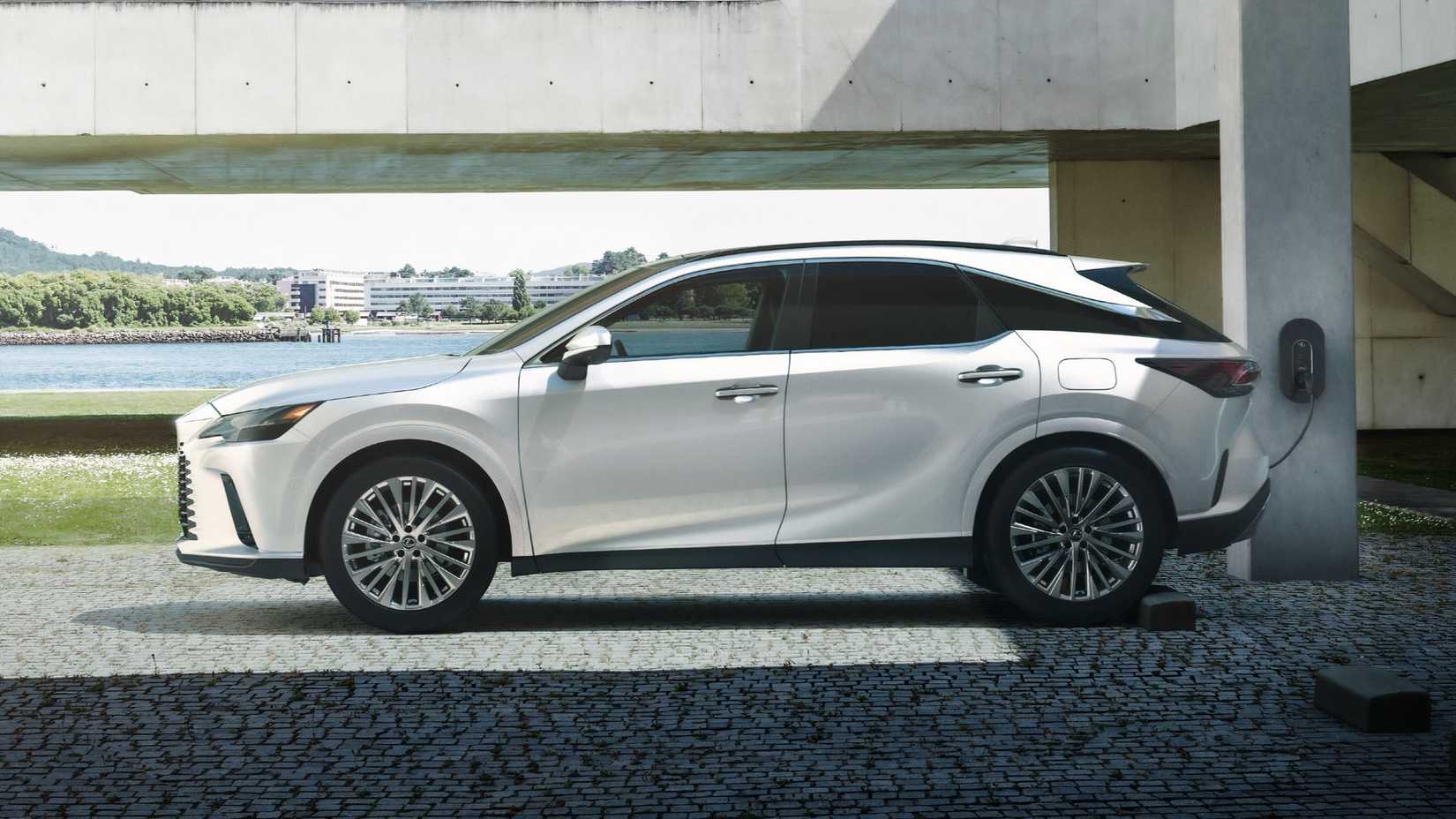 Side profile shot of a white Lexus RX midsize plug-in hybrid SUV. 