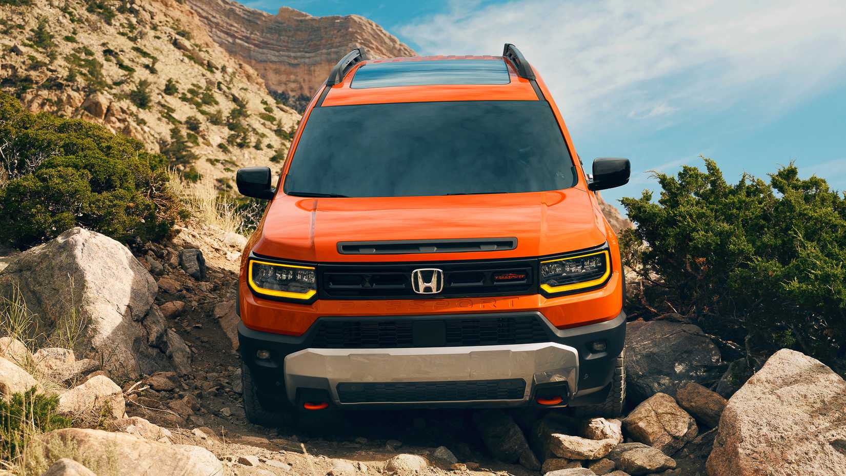 2026 Honda Passport TrailSport in orange traversing rocks