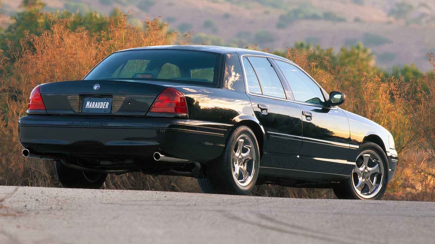 Um Mercury Marauder 2003 estacionado em uma laje de asfalto perto de uma árvore