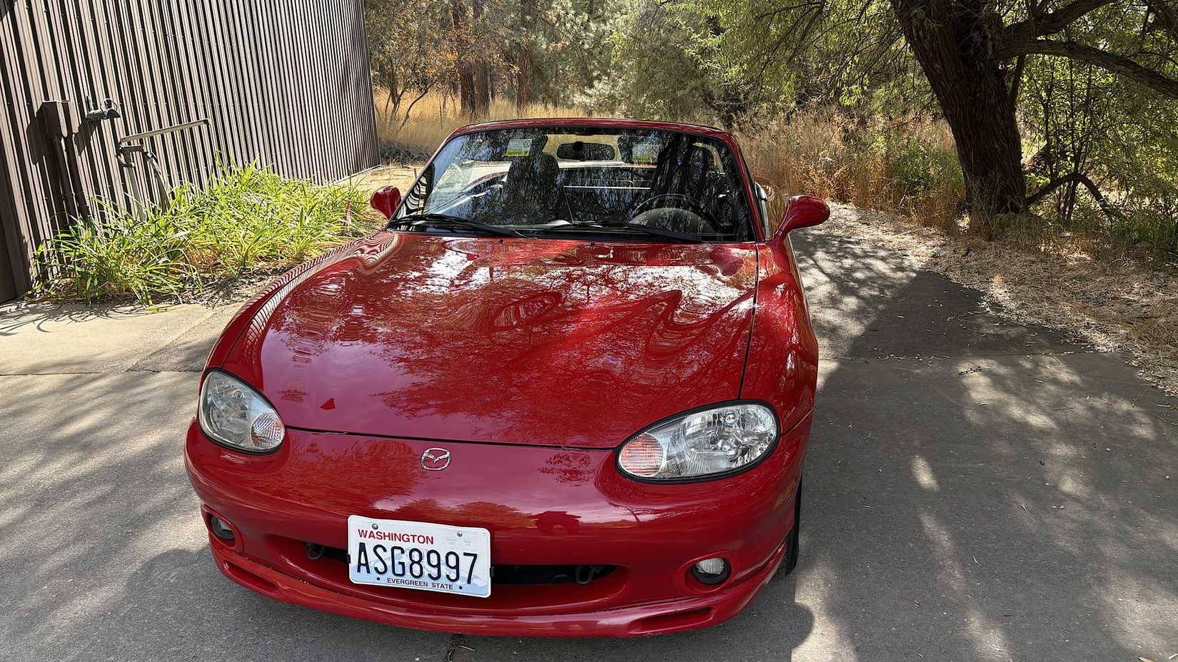 2000 Mazda MX-5 Miata in red parked on driveway